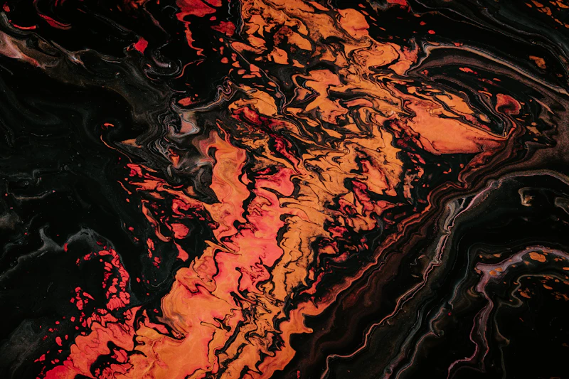 Orange liquid splash on black background — abstract fluid art